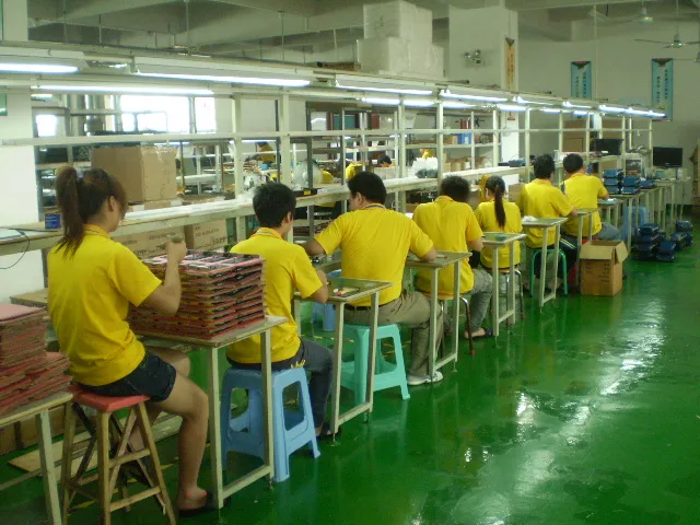 Staff working at an electronics assembly bench