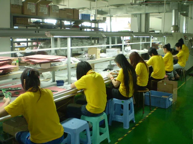 Circuit boards and staff at manual assembly workstations